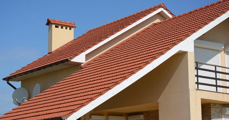 Close-up of a house roof with red tiles and a chimney in The Woodlands, Texas.